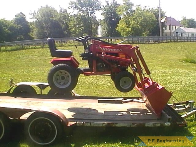this shows how strong a side mount sub frame design is to hold up the entire tractor. notice how the bucket is chained to the trailer.  | Ingersoll LGT 318 garden tractor loader_5